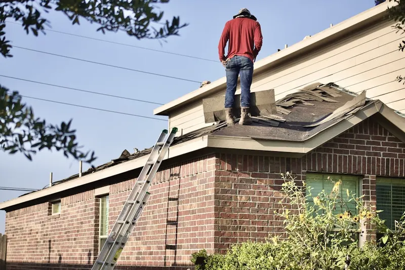 Professional roofer working on a residential roof in Independence Park